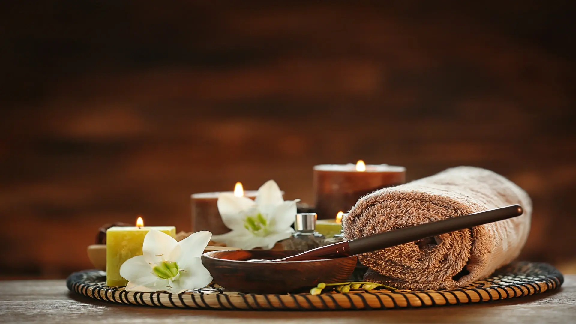Serene spa setting with candles and towel for a tranquil and relaxing experience.