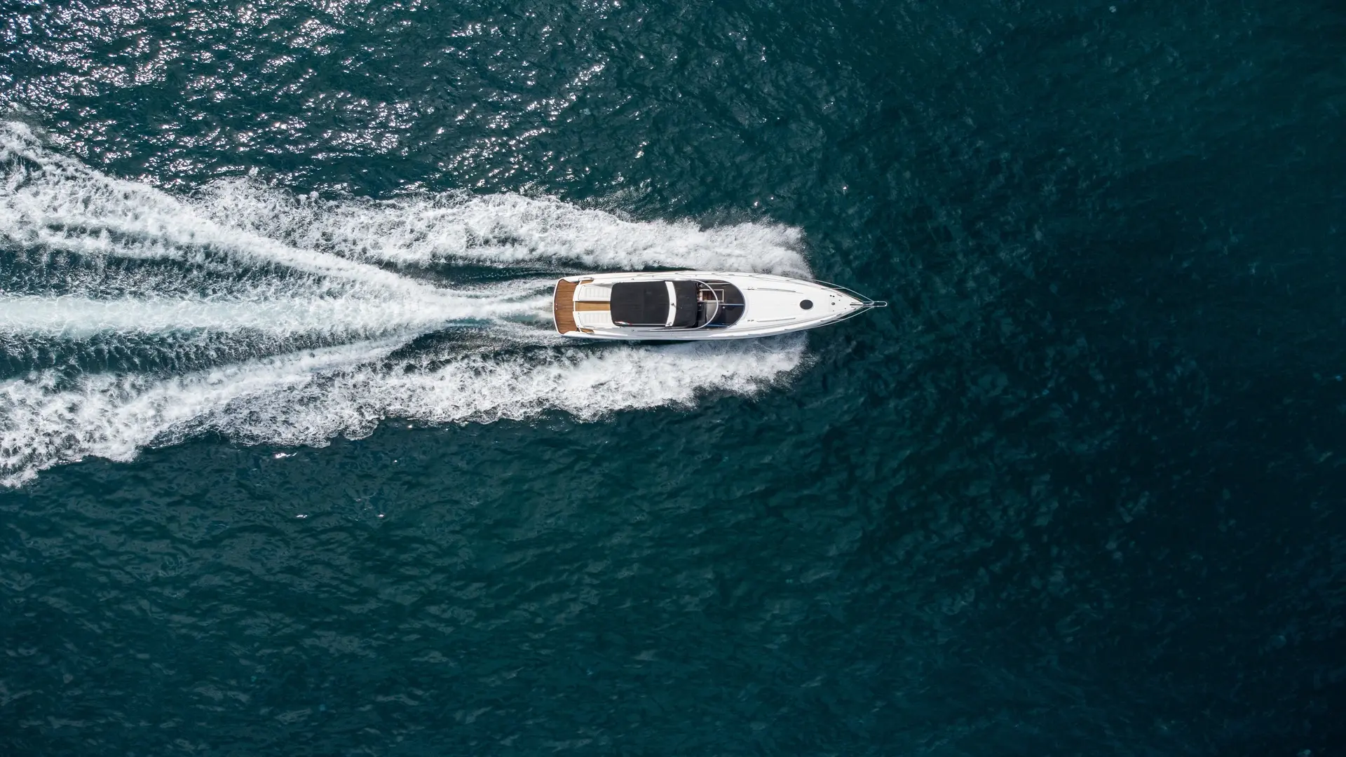 Aerial close-up of a boat on the ocean.